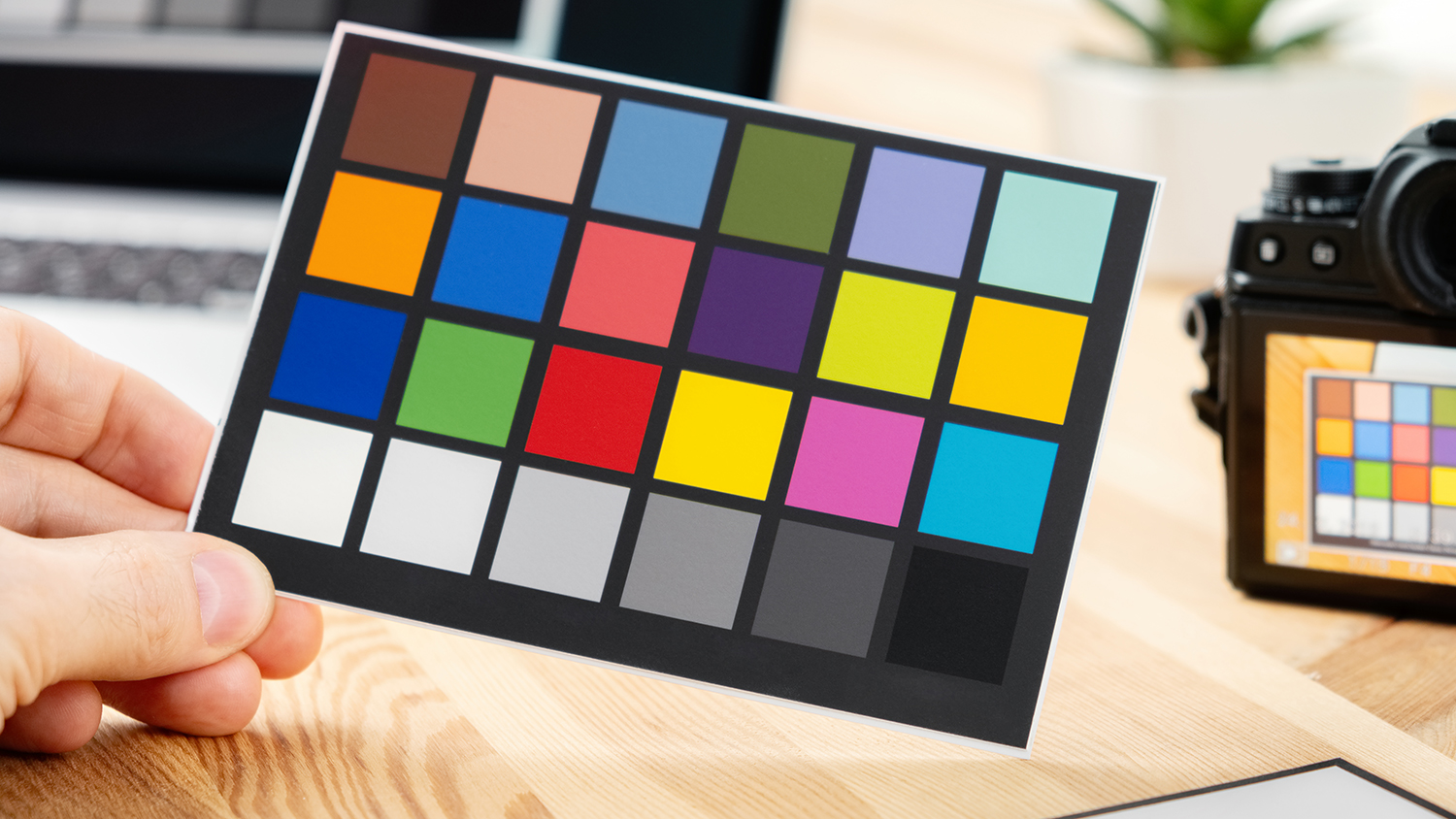 A color calibration chart next to a camera for accurate color reproduction.