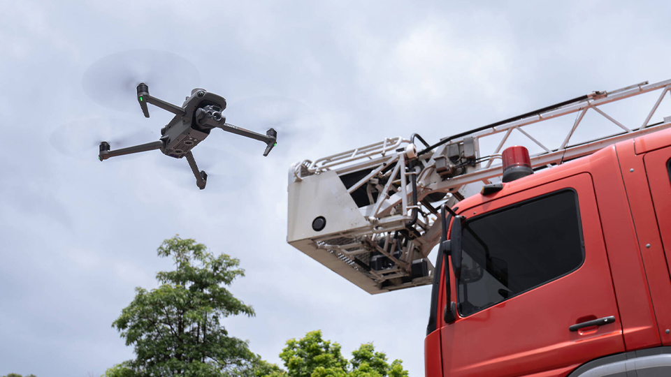 DJI Mavic 3 Thermal Drone hovering by firetruck