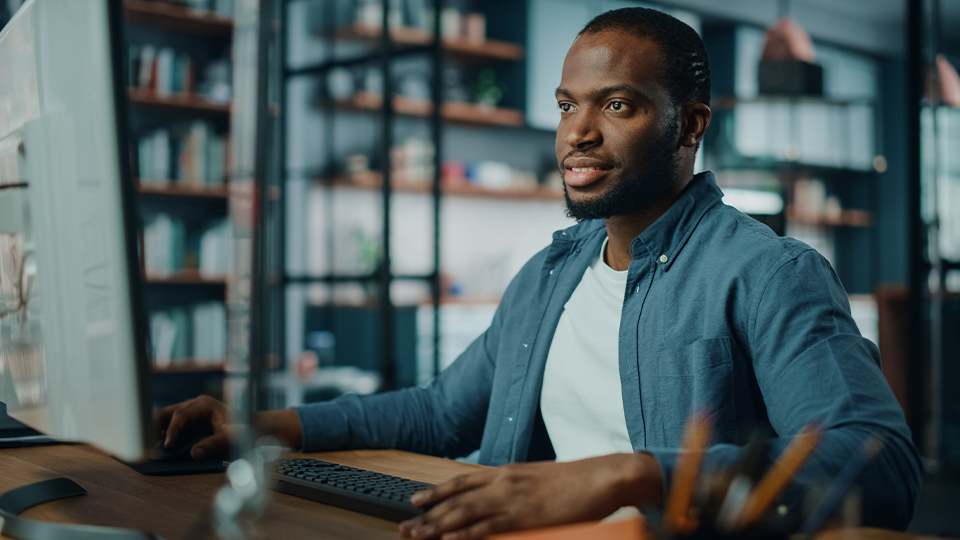 Man Reading on Home Desktop
