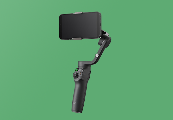 Full product shot of the DJI Osmo Mobile 6 iPhone camera stabilizer on a green background